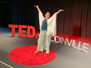 Woman on stage at TEDTalk