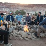 friends gathered around campfire