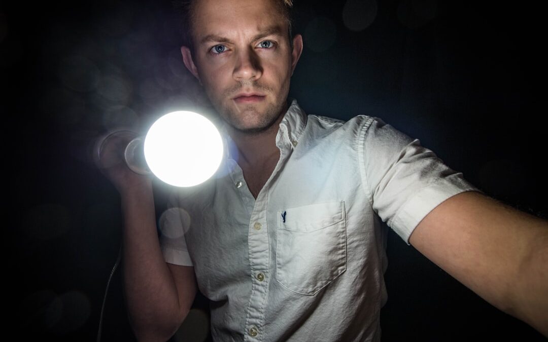 man in dark with flashlight