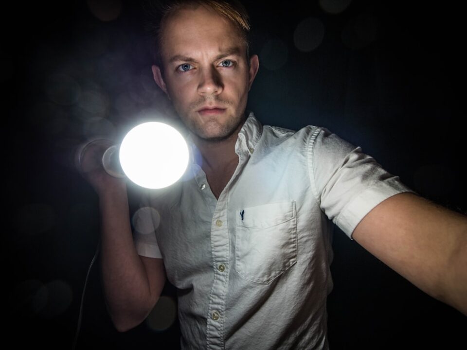 man in dark with flashlight