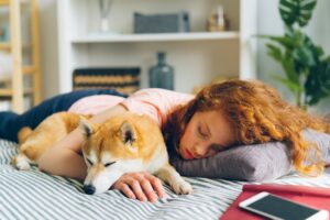 human and dog sleeping together